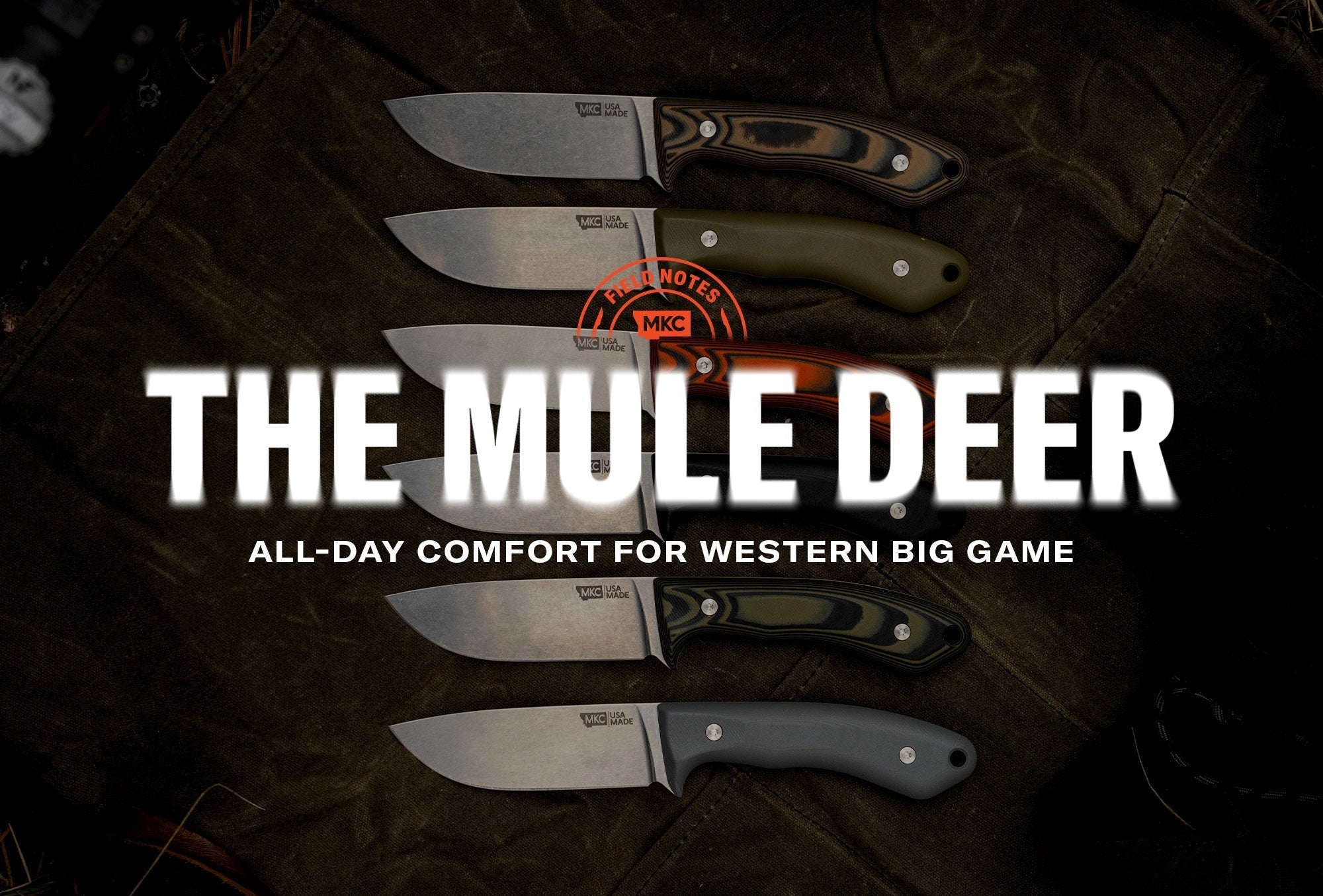Six MKC knives laid out on a dark surface for the Mule Deer knife blog.
