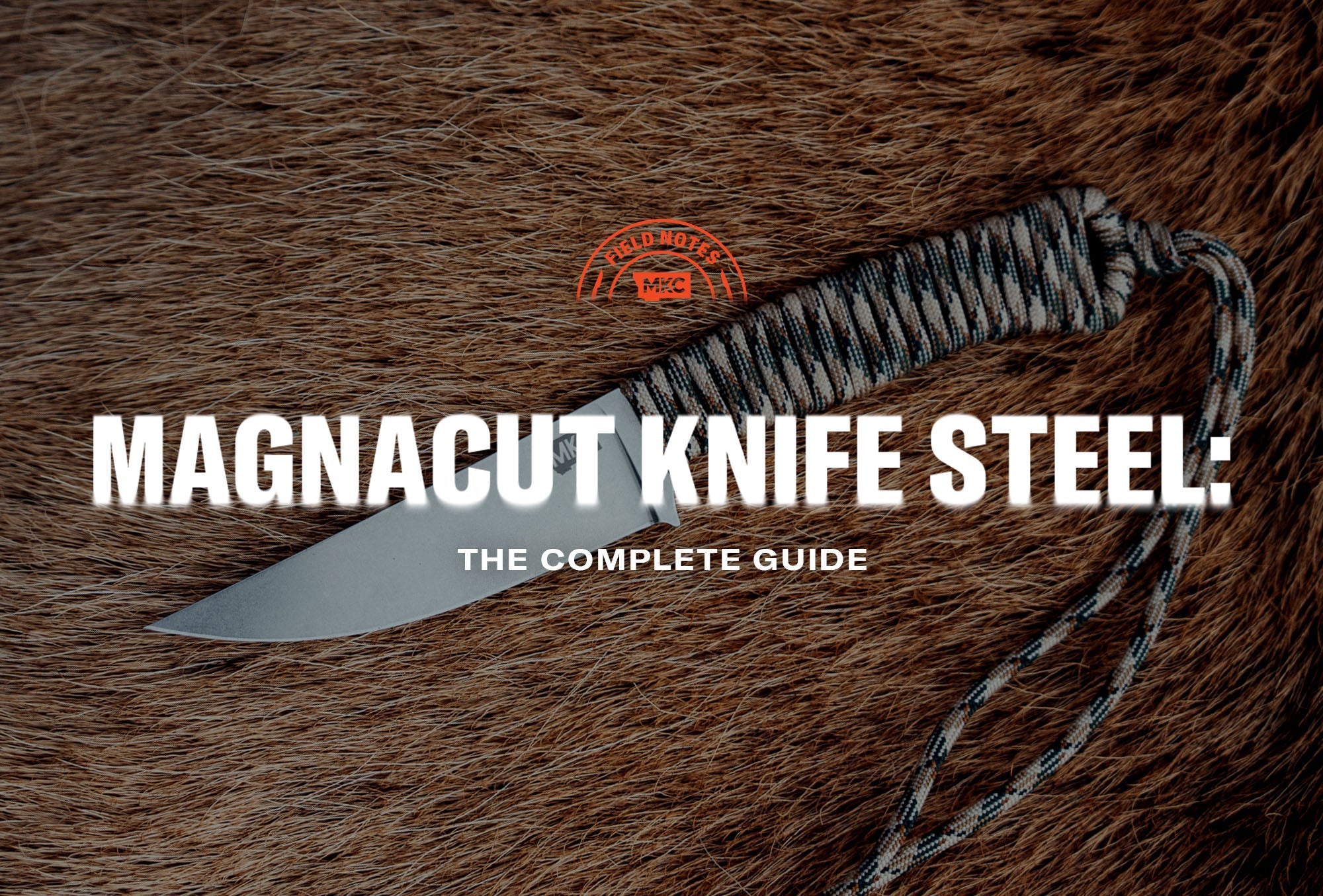 MKC Magnacut knife with a paracord-wrapped handle resting on animal hide.