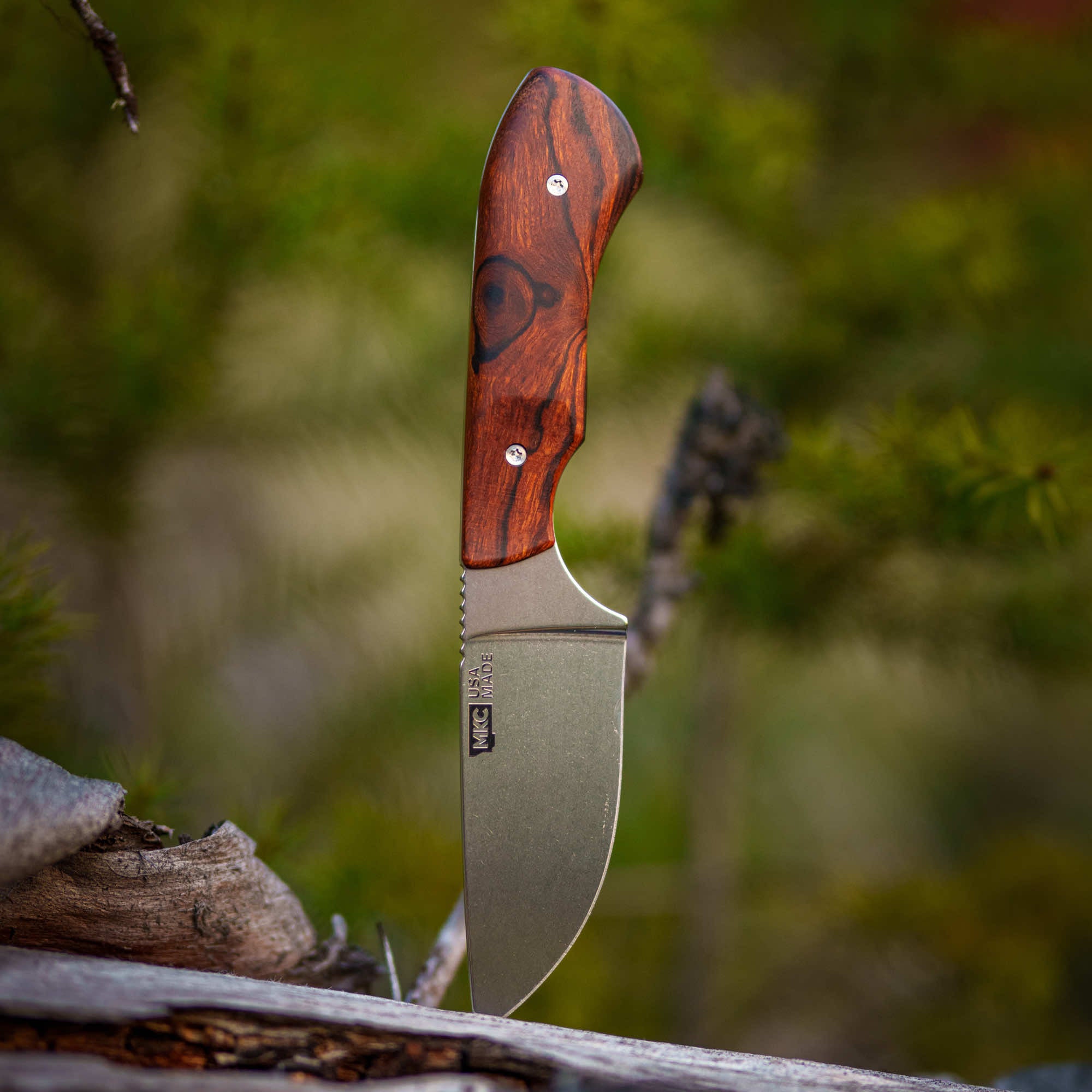 MKC Elk Knife with a wooden handle and a curved blade, designed for outdoor use and crafted in Montana.