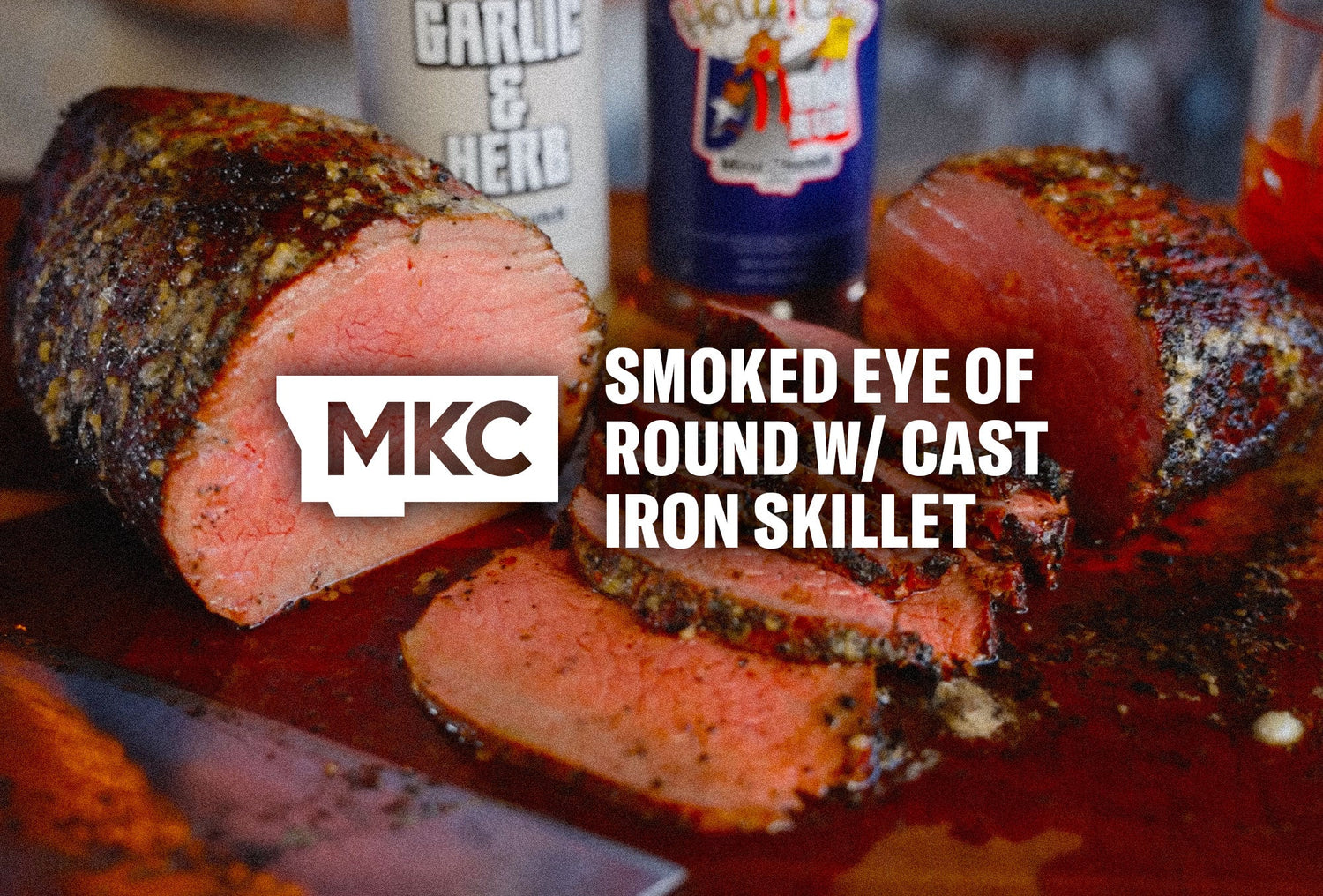 Juicy eye of round roast sliced thin, showing a seasoned crust from cast iron searing and slow smoking.