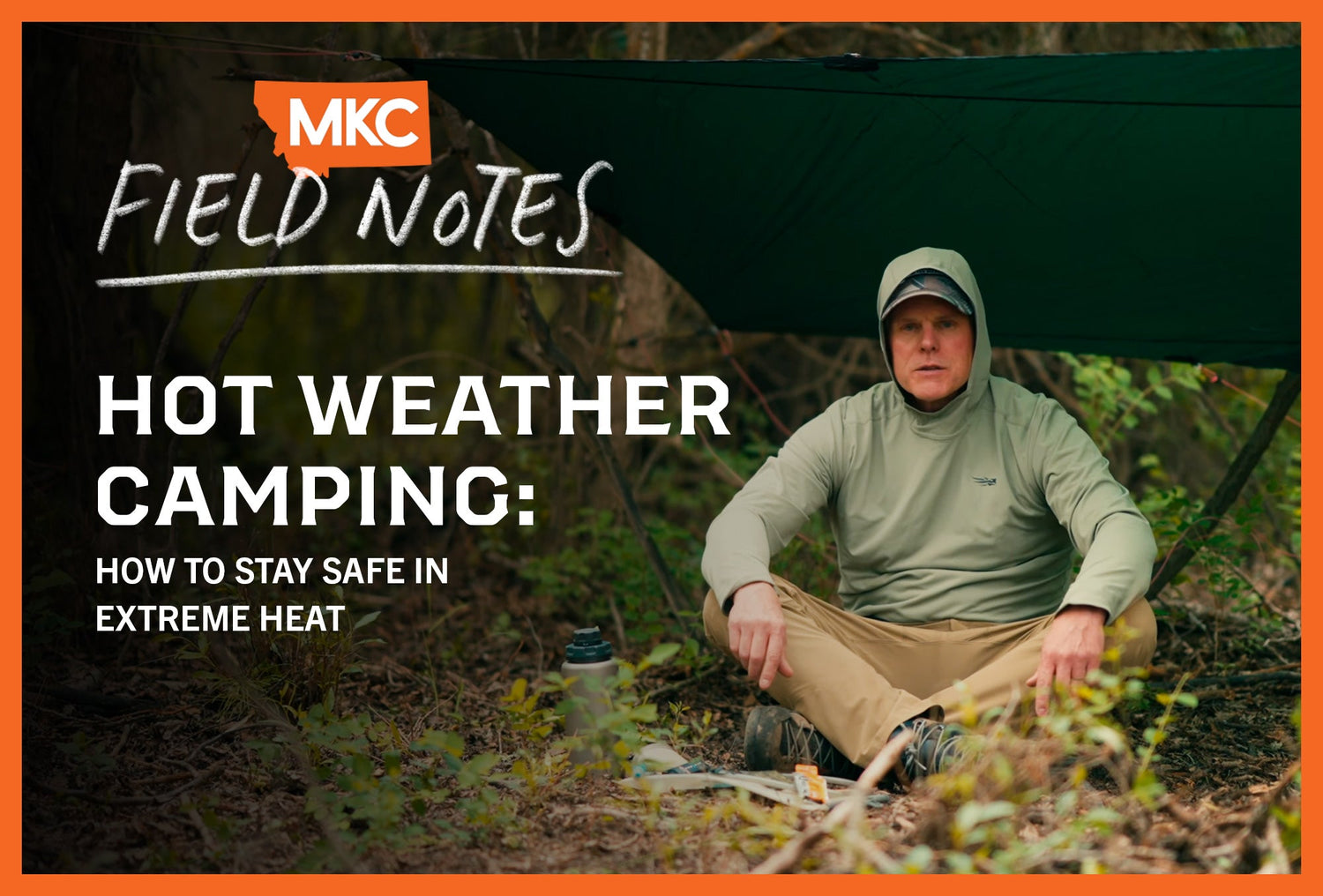 A camper in a light green hoodie sits under tarp in wilderness, seeking shade during extreme heat.