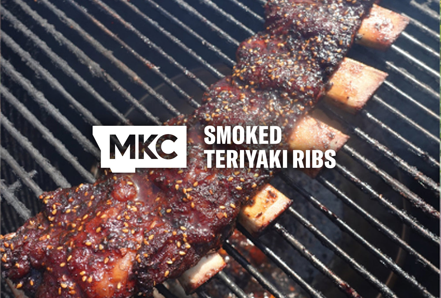 Smoked teriyaki ribs on a grill, glazed and caramelized with sesame seeds on the surface.