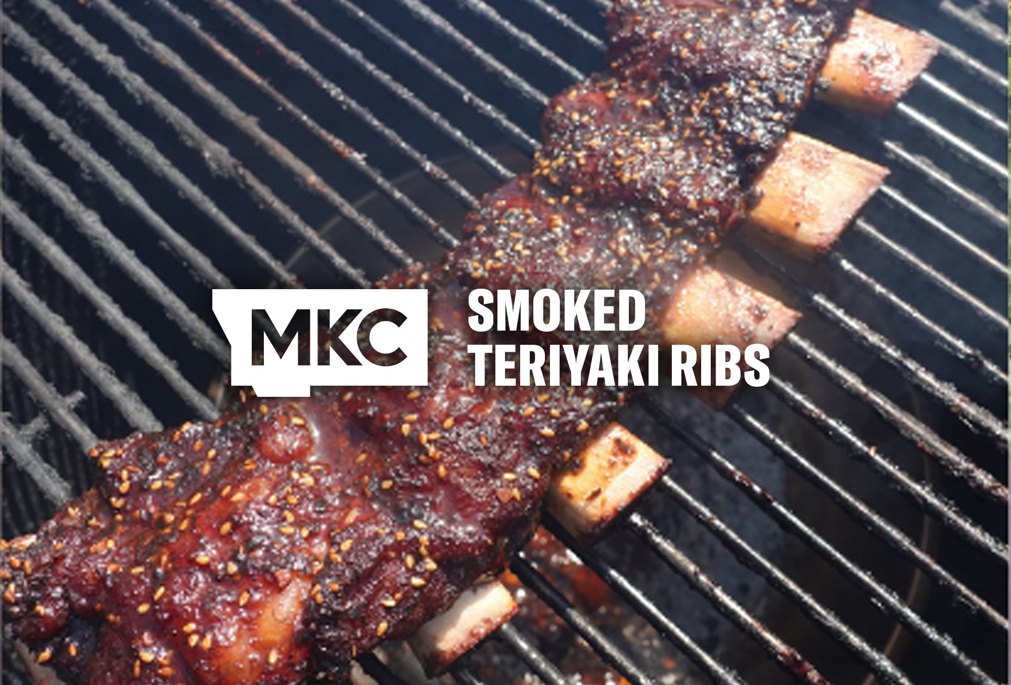 Smoked teriyaki ribs on a grill, glazed and caramelized with sesame seeds on the surface.
