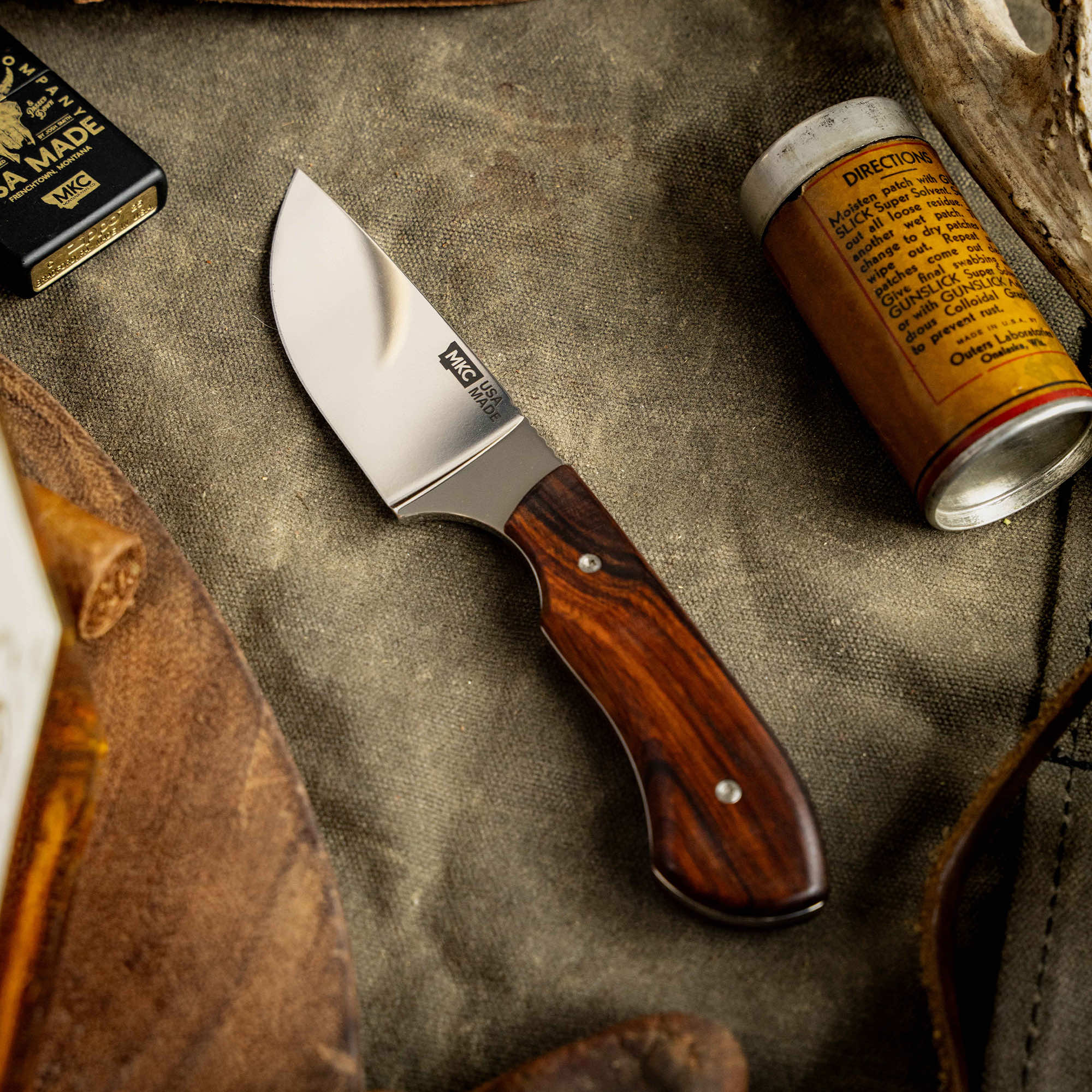 Montana Knife Company's LIVE WILD Traditions Elk Knife features a sleek blade and a polished wood handle, ideal for outdoor enthusiasts.