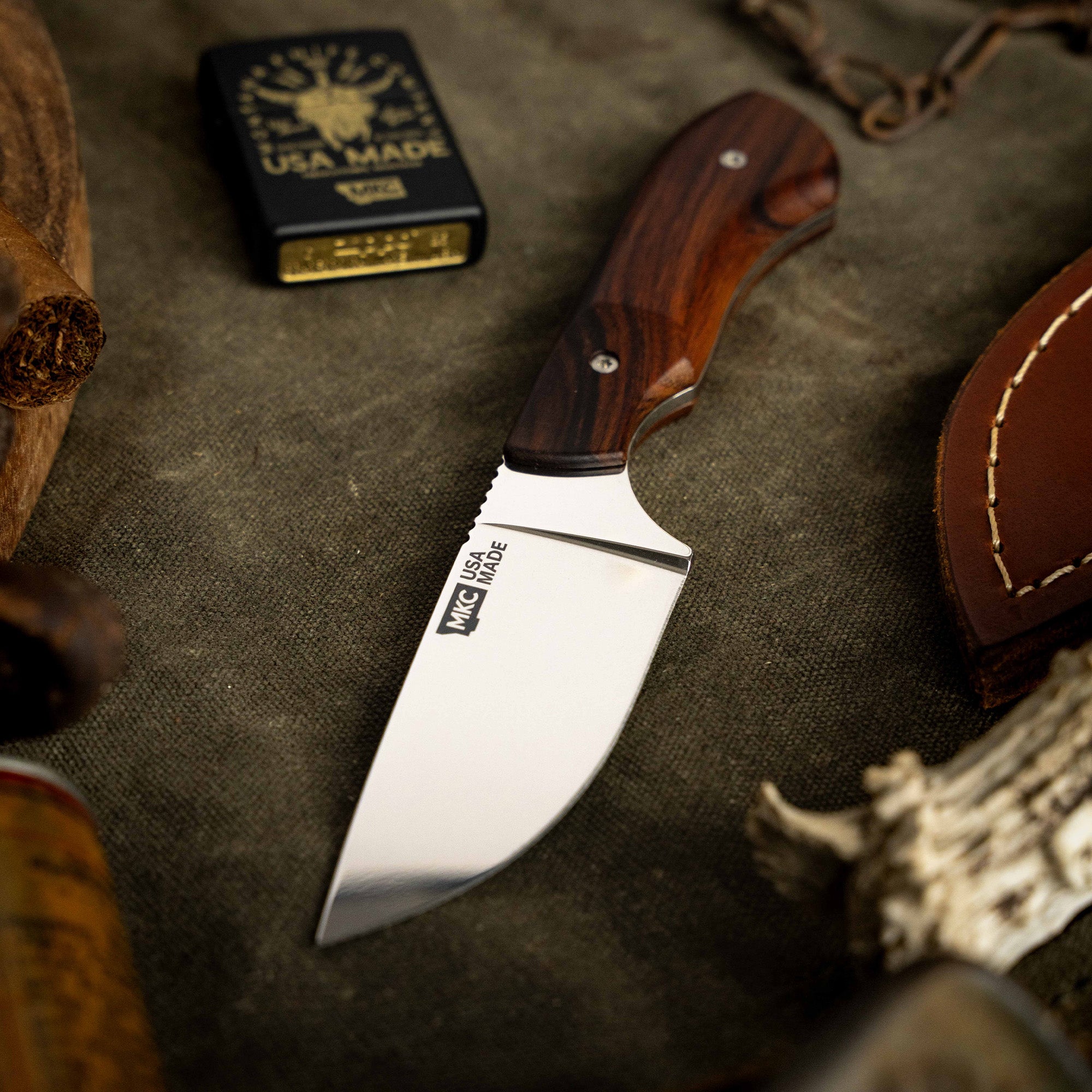 Montana Knife Company's LIVE WILD Traditions Elk Knife features a sleek blade and a beautifully crafted wooden handle.